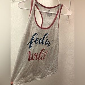 “Feeling wild” no sleeve top. Never worn !!